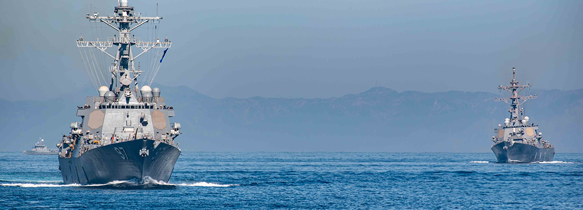 USS Halsey (DDG 97), front, and USS Paul Hamilton (DDG 60) sail in formation with the Nimitz-class aircraft carrier USS Theodore Roosevelt (CVN 71), and other Carrier Strike Group Nine (CSG-9) ships in the Pacific Ocean, Nov. 10, 2023.